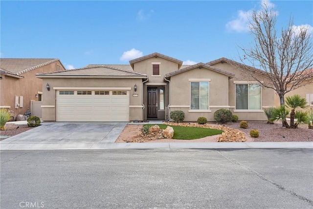 single story home with a garage, concrete driveway, a tiled roof, and stucco siding