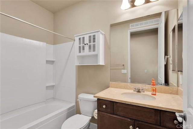 full bath with shower / tub combination, vanity, and toilet