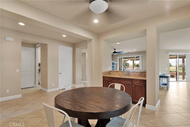 dining space with light tile patterned floors, baseboards, and recessed lighting