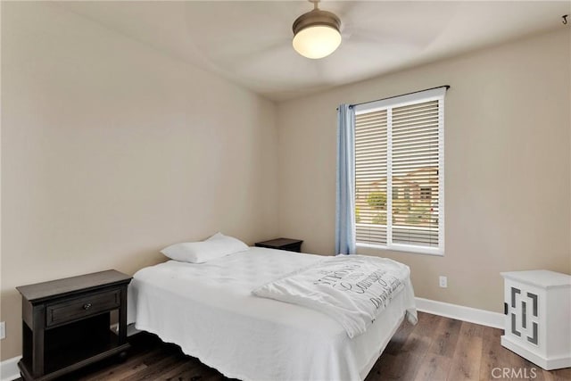 bedroom with wood finished floors and baseboards