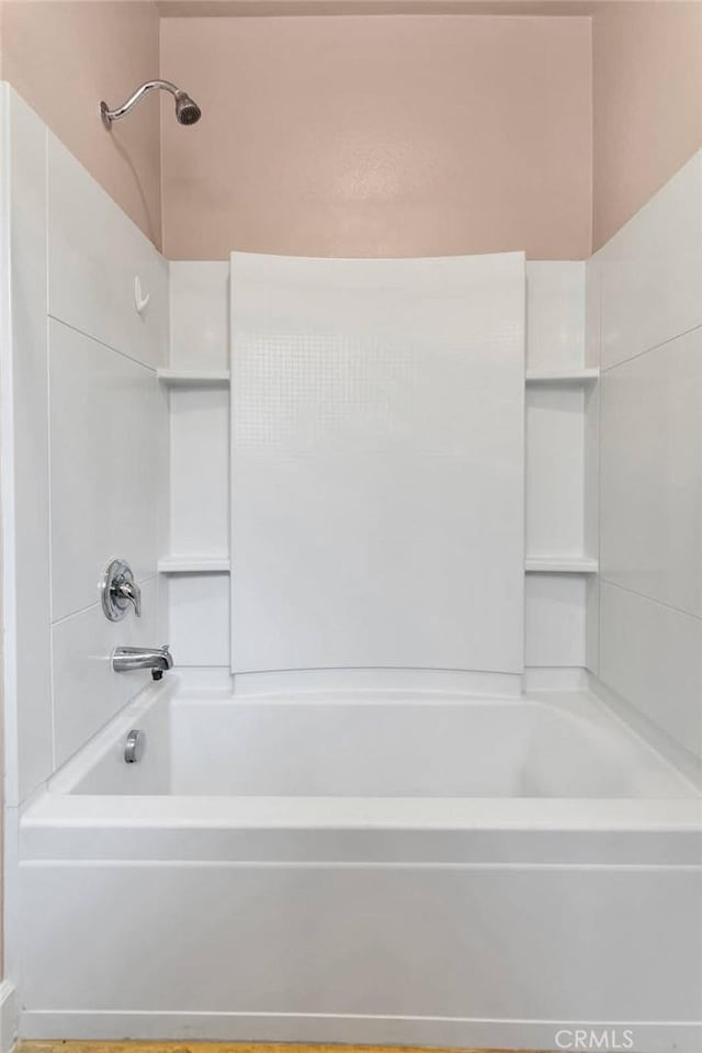 bathroom with bathing tub / shower combination