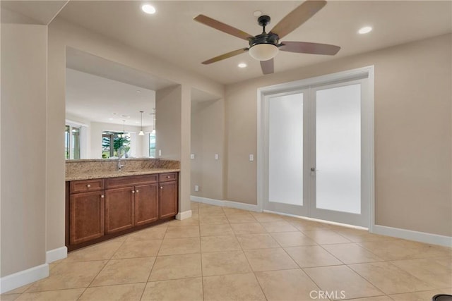 kitchen featuring recessed lighting, french doors, a sink, and light tile patterned floors