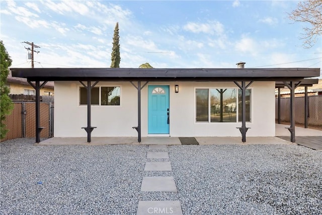 back of property featuring a patio, fence, and stucco siding