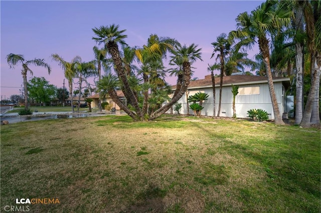 view of yard at dusk