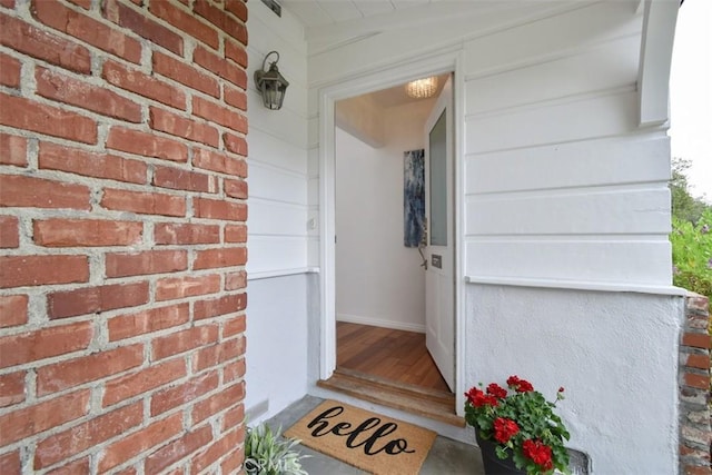 property entrance featuring brick siding