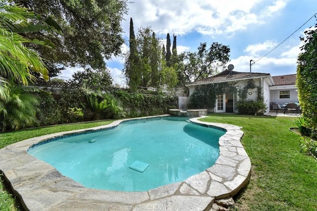 view of swimming pool with a patio, a lawn, and a pool with connected hot tub