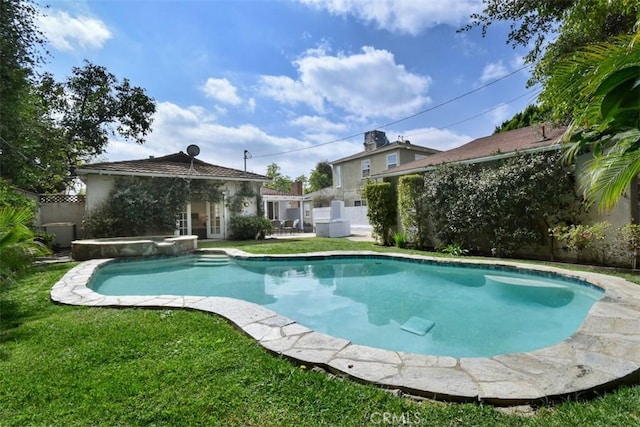 view of swimming pool with a pool with connected hot tub, a fenced backyard, a lawn, and french doors