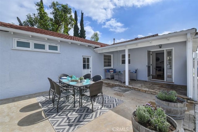 view of patio / terrace with outdoor dining space and an outdoor living space