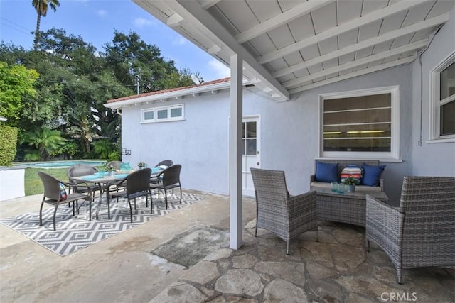 view of patio / terrace with outdoor dining space and an outdoor pool