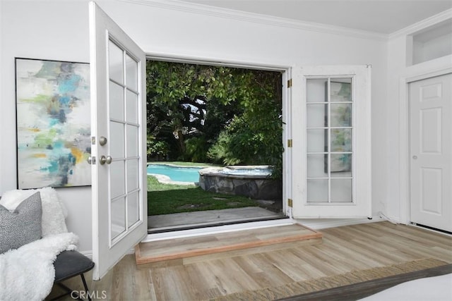 doorway with crown molding and wood finished floors