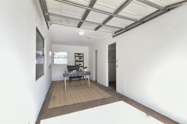 home office featuring a garage and finished concrete floors