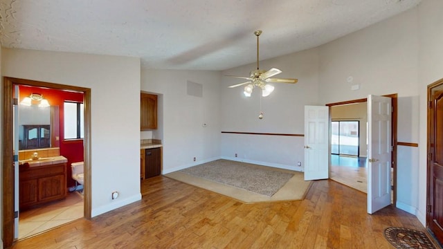 empty room featuring visible vents, ceiling fan, light wood-style flooring, and baseboards