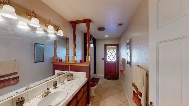 bathroom with tile patterned flooring, visible vents, and vanity