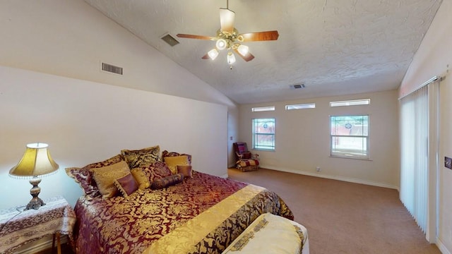 bedroom featuring a textured ceiling, carpet floors, visible vents, a ceiling fan, and vaulted ceiling