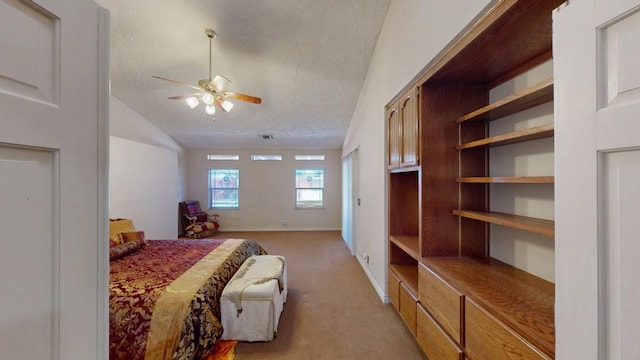 bedroom with light carpet, visible vents, baseboards, lofted ceiling, and a textured ceiling