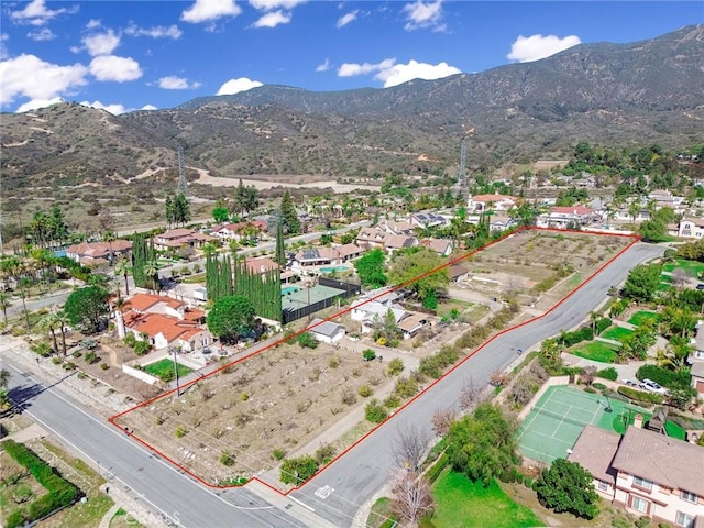 drone / aerial view featuring a residential view and a mountain view