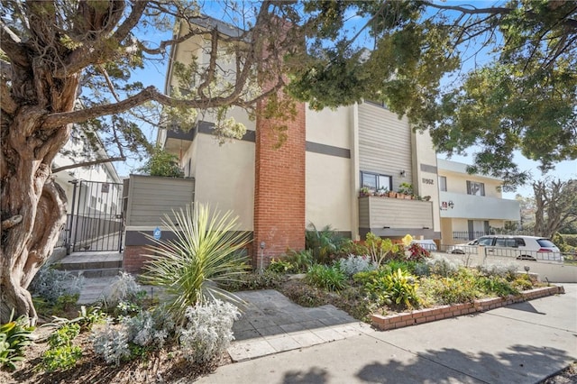 view of home's exterior featuring a gate and stucco siding