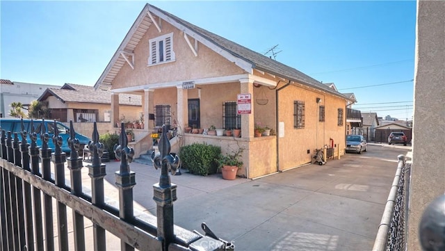 view of front facade featuring fence and stucco siding