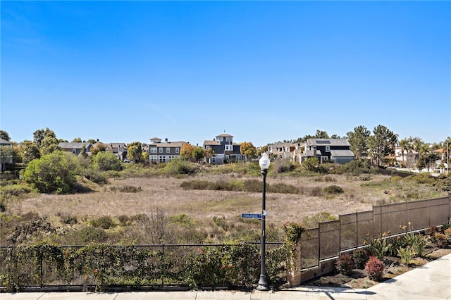 view of yard with a residential view and fence