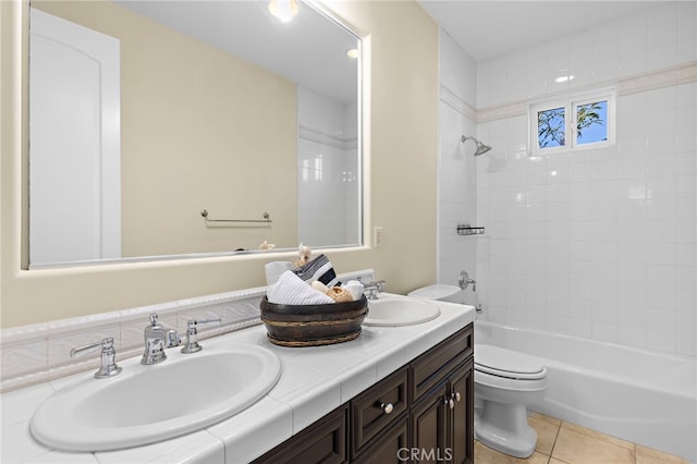 full bath with tile patterned floors, toilet, shower / bathtub combination, and a sink