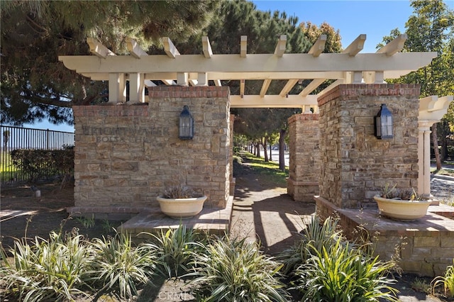 view of patio / terrace with a pergola, a fireplace, and fence