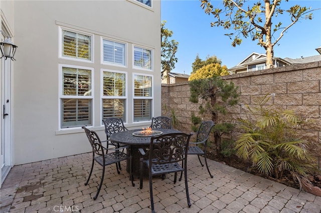 view of patio with outdoor dining space and fence