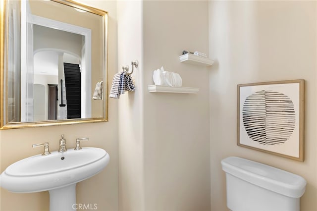 half bath with a sink and toilet