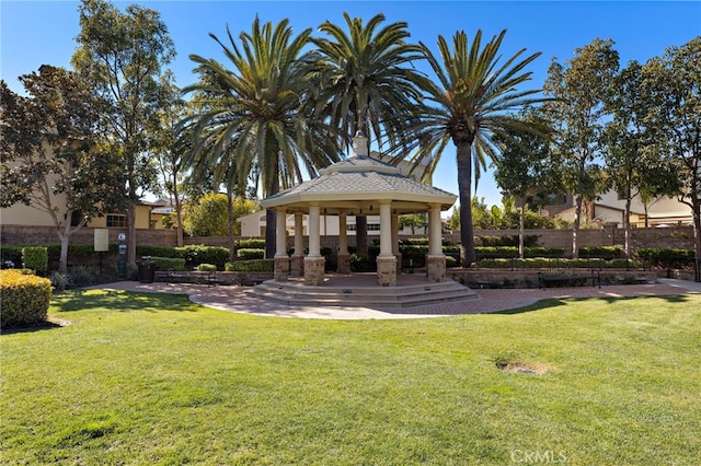 view of home's community with a gazebo, a lawn, and fence