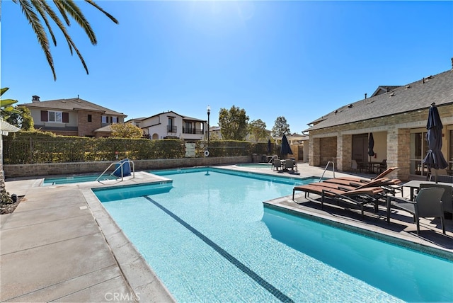 pool featuring a patio and fence