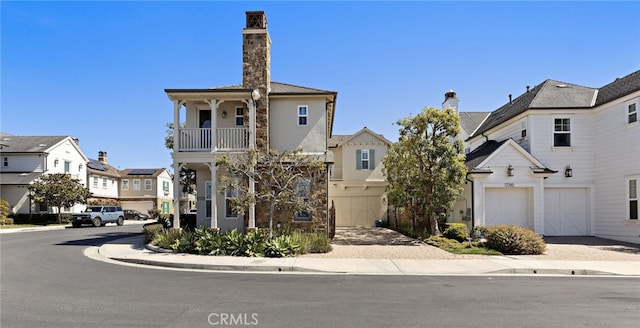 view of front of home featuring decorative driveway, a residential view, and a garage