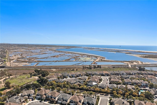 drone / aerial view featuring a residential view and a water view