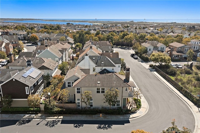 birds eye view of property with a residential view and a water view