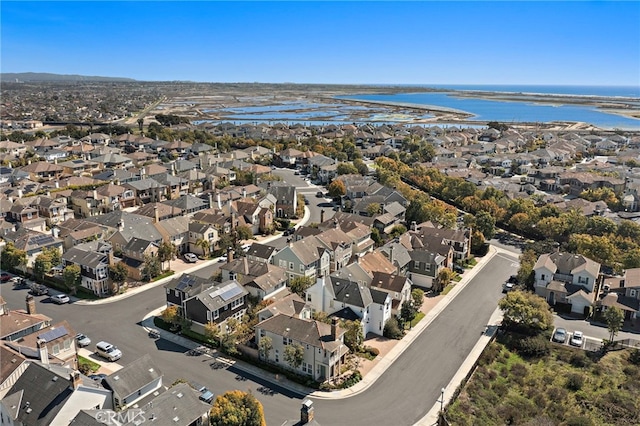 drone / aerial view featuring a water view and a residential view