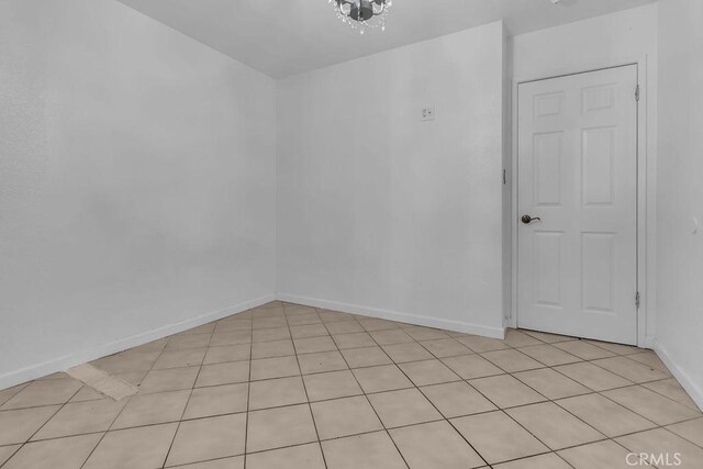 unfurnished room with baseboards