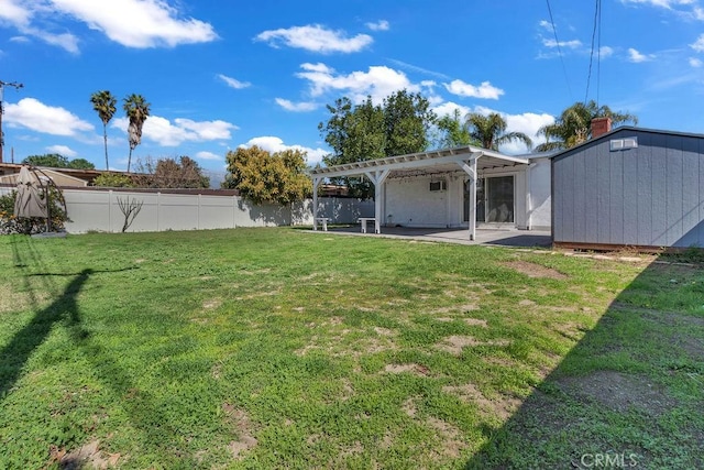 view of yard with a fenced backyard, a storage unit, a pergola, and an outbuilding