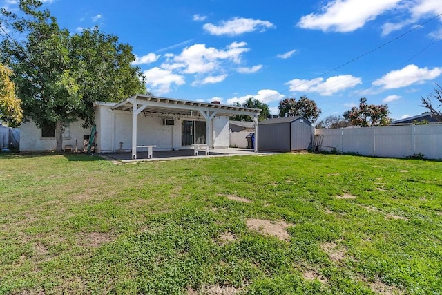 back of house featuring an outbuilding, a patio, a fenced backyard, a yard, and a shed