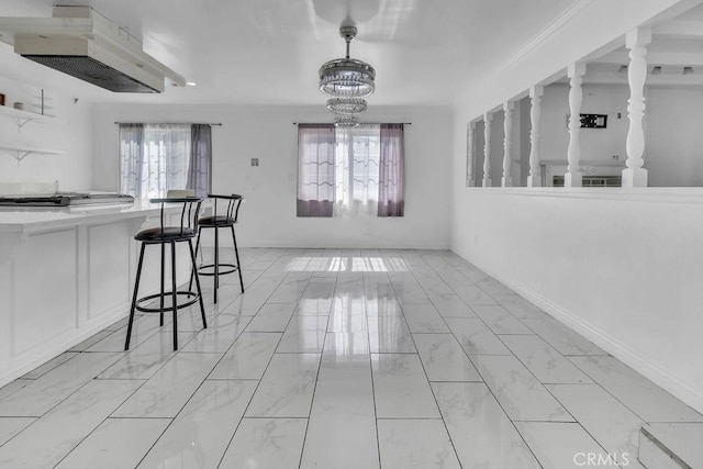 dining area with baseboards, marble finish floor, an inviting chandelier, and crown molding