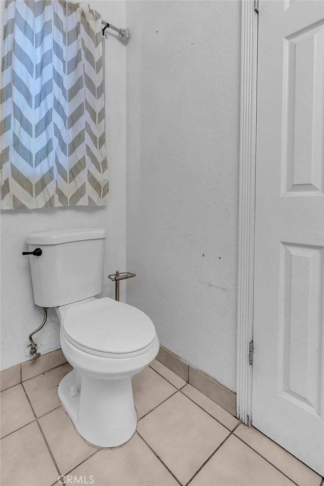 bathroom featuring toilet and tile patterned floors