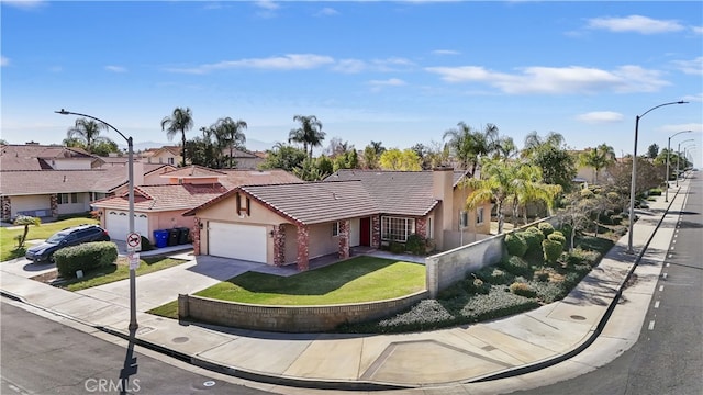 view of front of house featuring fence, driveway, a tiled roof, a residential view, and stucco siding