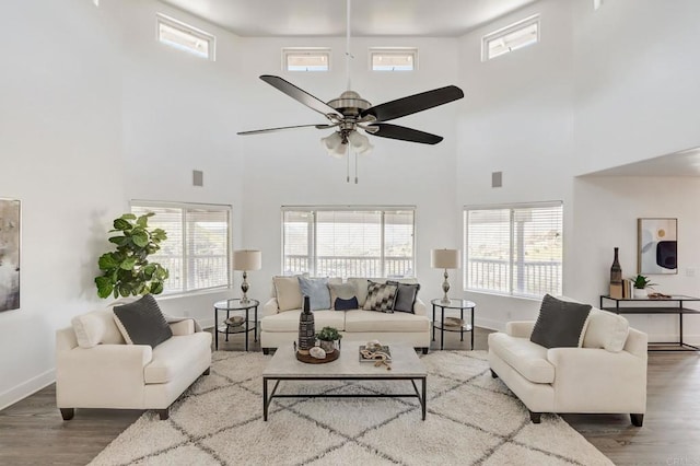 living area featuring plenty of natural light, wood finished floors, and baseboards