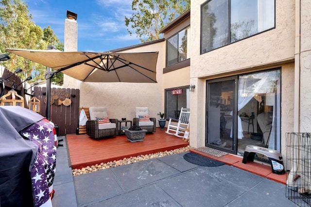 view of patio / terrace with a deck and fence