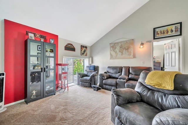 carpeted living area with high vaulted ceiling