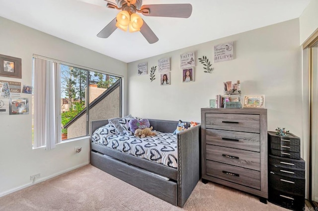 bedroom featuring a ceiling fan, baseboards, and carpet flooring