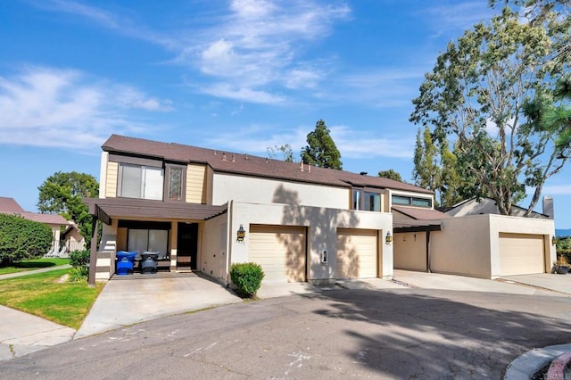 view of front of home with a garage and stucco siding