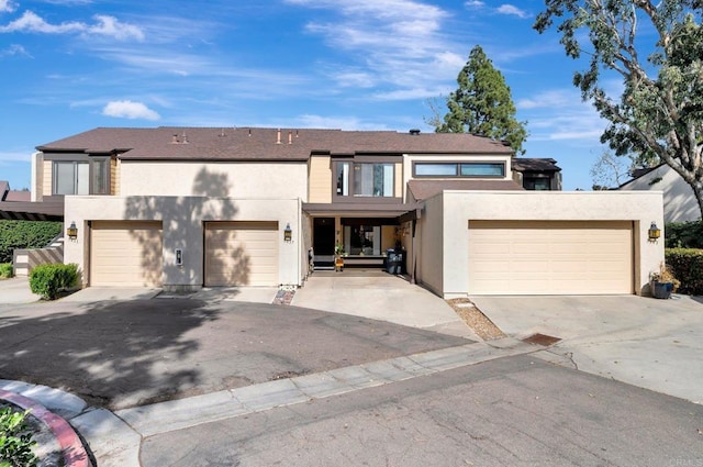 view of property with driveway and stucco siding