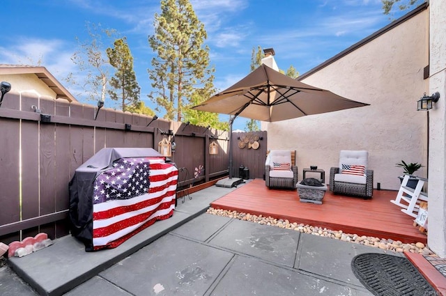 view of patio / terrace with a deck and a fenced backyard