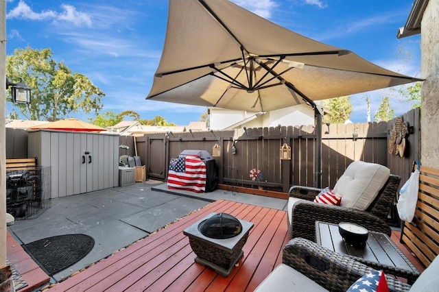 wooden deck featuring a fenced backyard