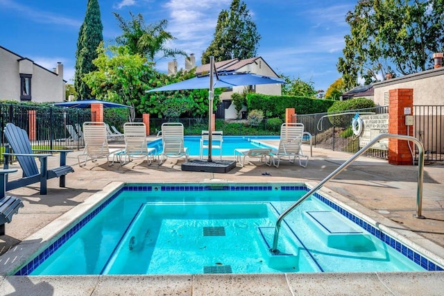 community pool featuring a patio area and fence