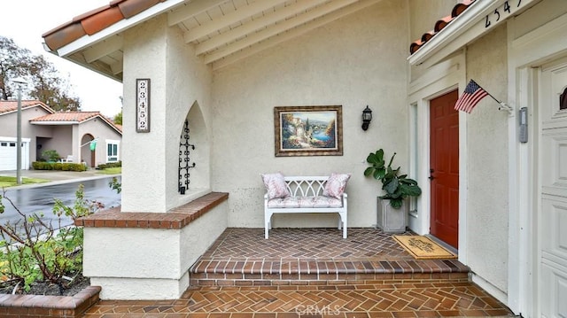 doorway to property featuring stucco siding