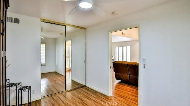 interior space with wood finished floors, visible vents, and baseboards